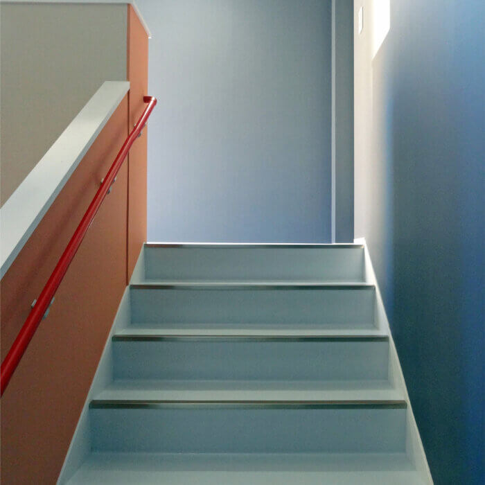 DFビル　内装デザイン　水色とオレンジの壁紙の階段